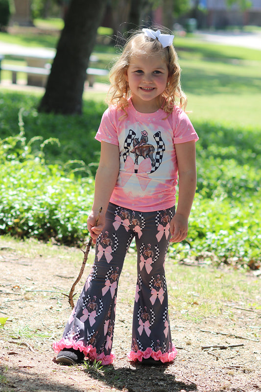 Coquette Horseshoe on pink tee shirt & ruffle pants.