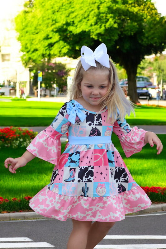 Beautiful wester patch printed girls dress with bows and cow printed hem.
