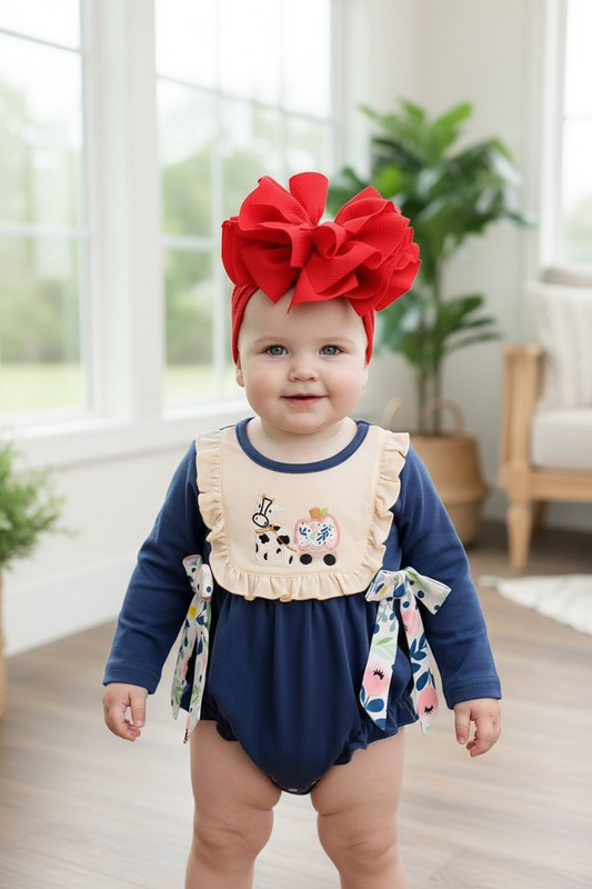 Navy blue cow applique baby onesie with snaps.