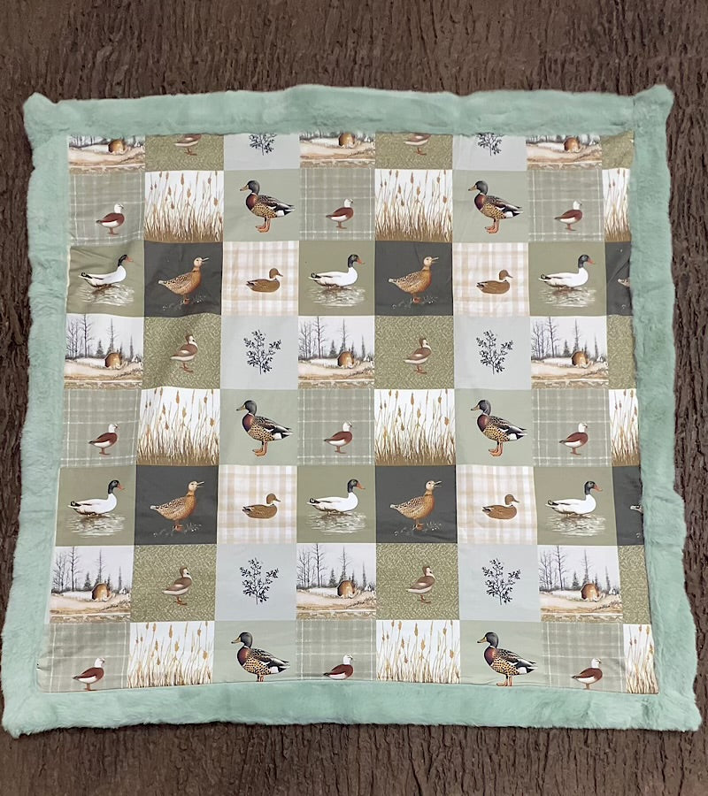 32 inch x 32 inch multi printed duck baby blanket with mint faux fur.