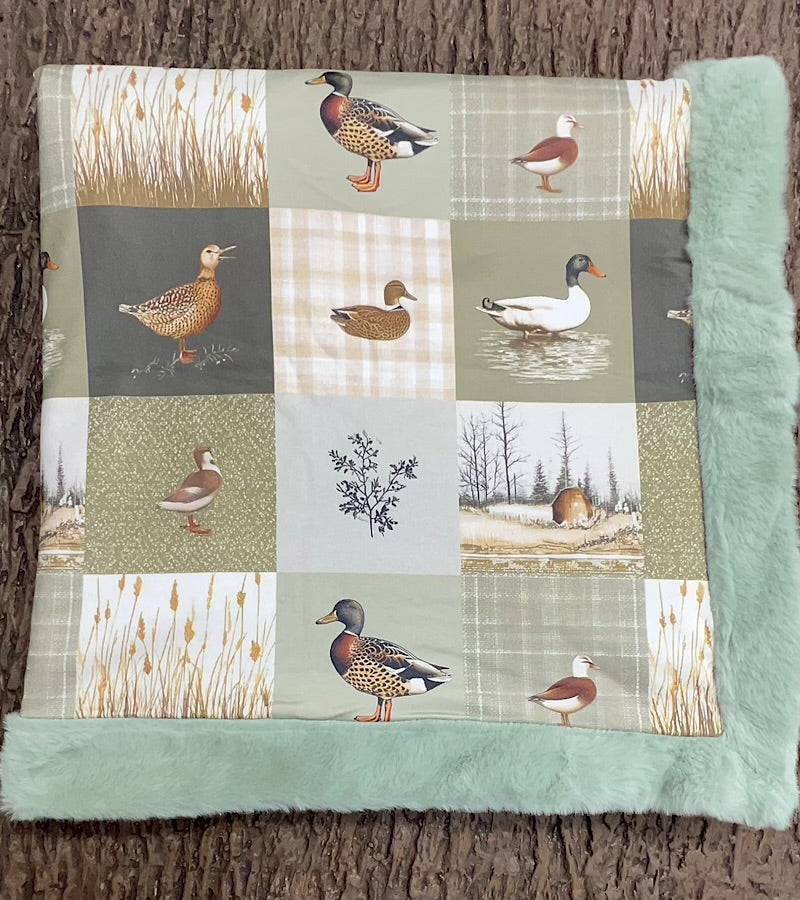 32 inch x 32 inch multi printed duck baby blanket with mint faux fur.