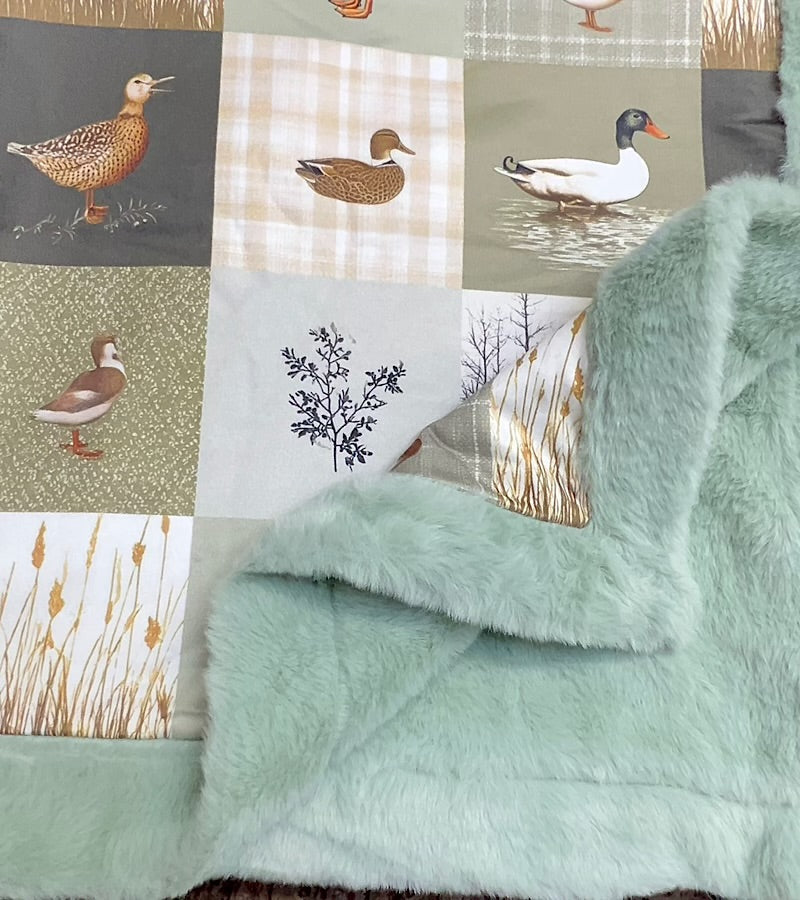 32 inch x 32 inch multi printed duck baby blanket with mint faux fur.
