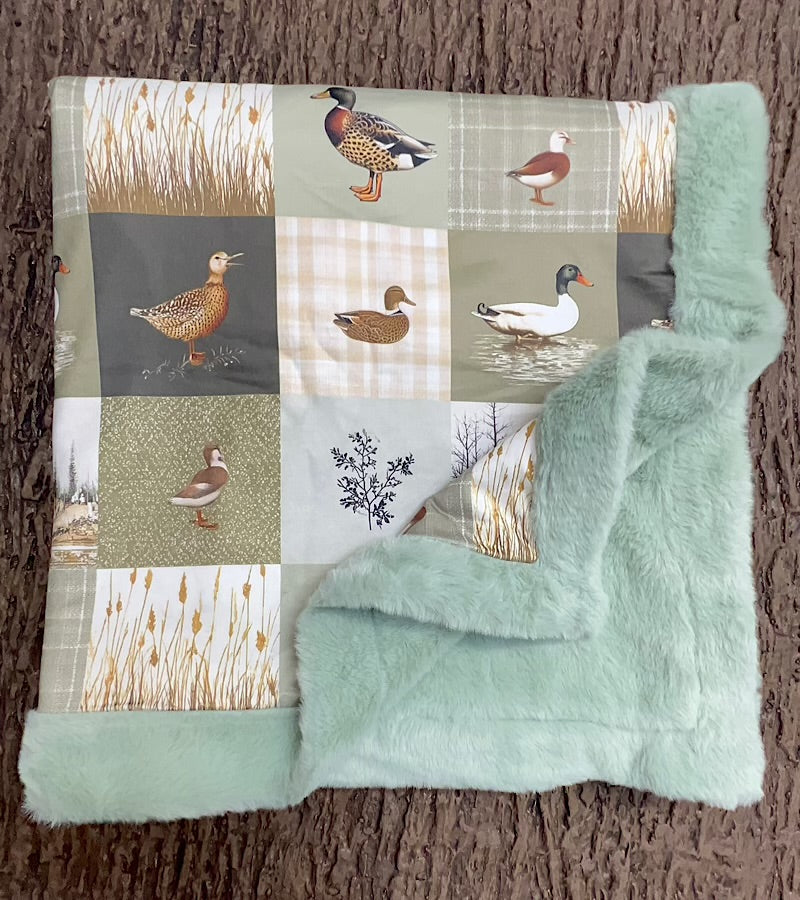 32 inch x 32 inch multi printed duck baby blanket with mint faux fur.