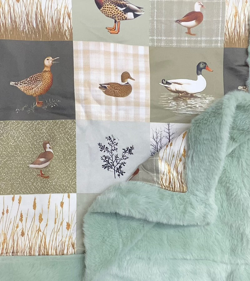 32 inch x 32 inch multi printed duck baby blanket with mint faux fur.