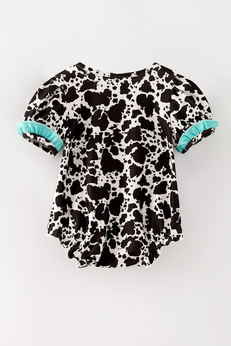 Cow printed baby romper with aqua ruffle hem. RPG64274 -M-