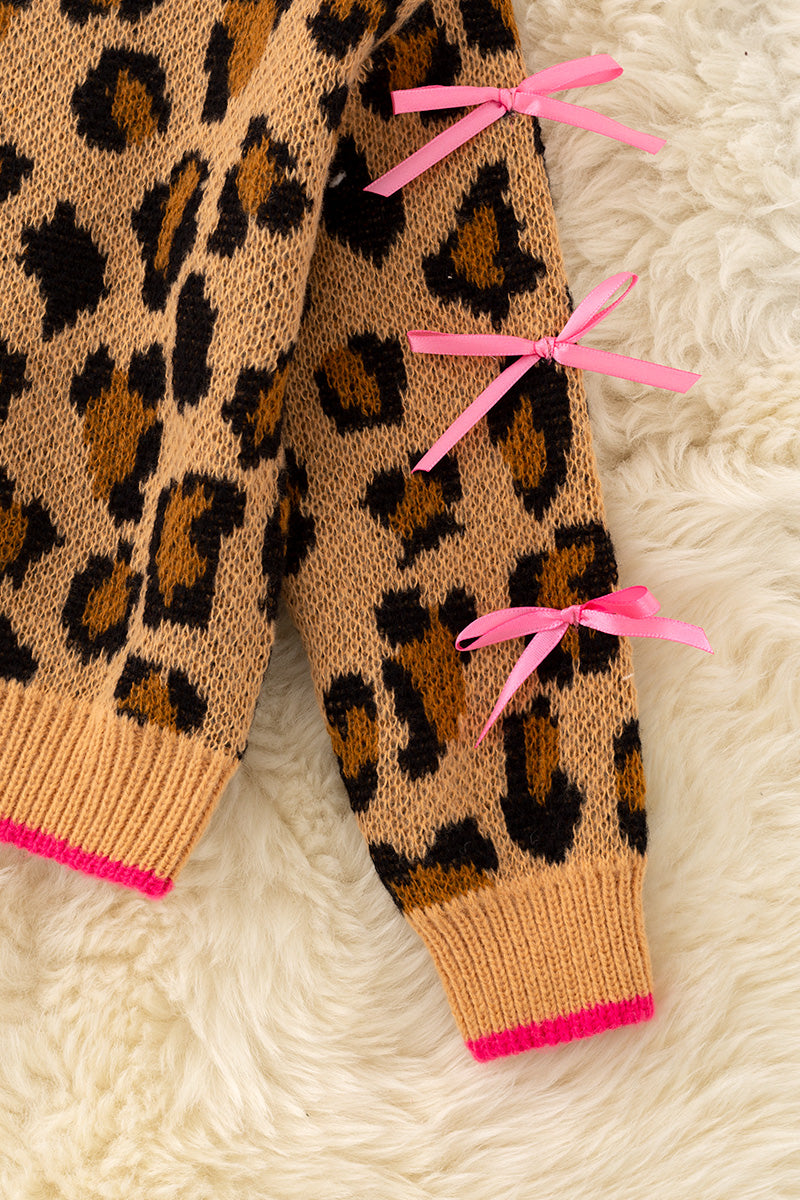 Leopard printed pullover sweater with fuchsia trim and lt. pink bows on sleeves. TPG60423