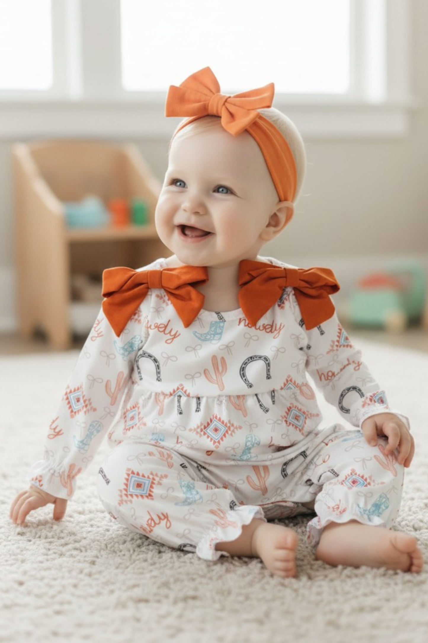 Howdy" printed girls baby romper w/rust side bows. A2026-S-